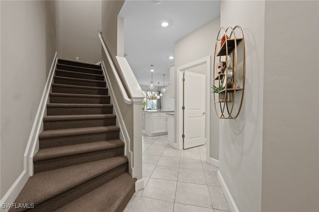 stairway featuring tile patterned floors, recessed lighting, and baseboards