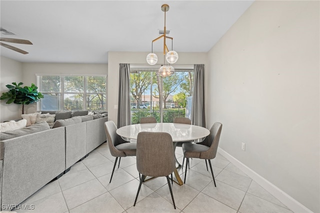 dining area featuring light tile patterned flooring, visible vents, a healthy amount of sunlight, and ceiling fan