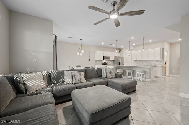 living room with visible vents, baseboards, recessed lighting, light tile patterned flooring, and a ceiling fan