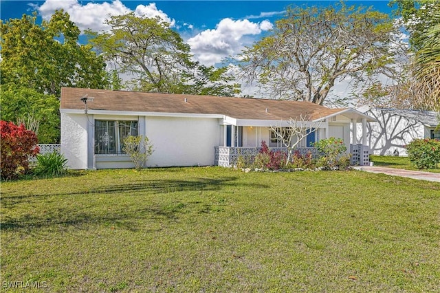 single story home with stucco siding, driveway, and a front lawn