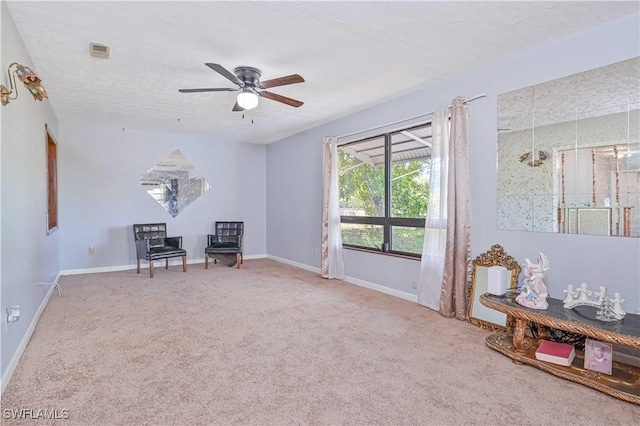 unfurnished room featuring visible vents, baseboards, ceiling fan, and carpet floors