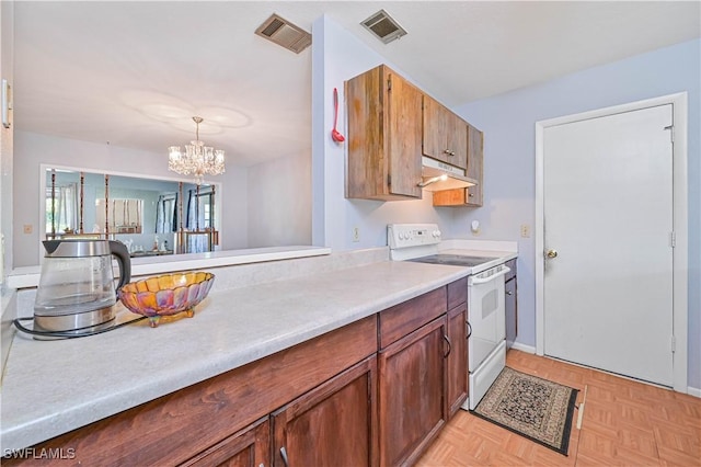 kitchen with light countertops, visible vents, under cabinet range hood, and white range with electric stovetop