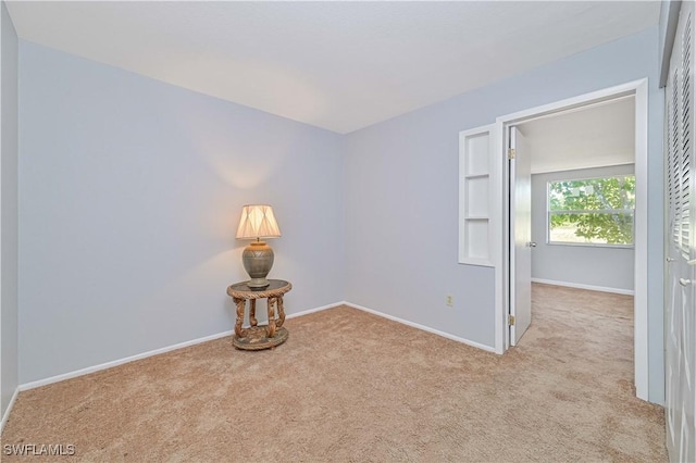 carpeted spare room with baseboards