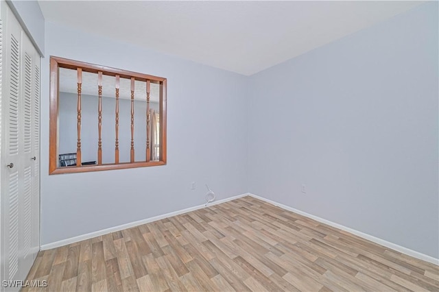 unfurnished room featuring baseboards and wood finished floors