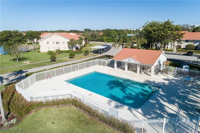 community pool featuring a patio area and a fenced backyard