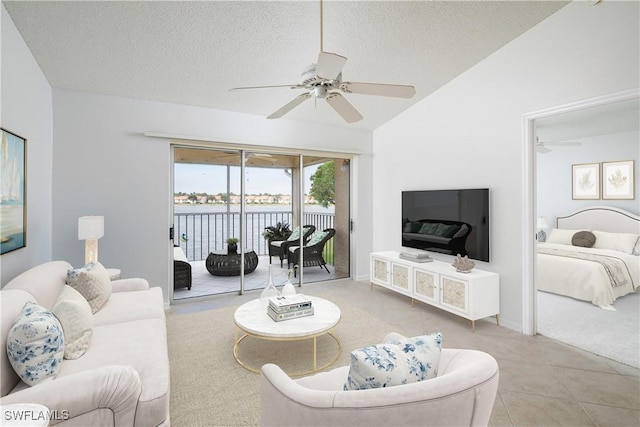 tiled living room featuring a textured ceiling, vaulted ceiling, and ceiling fan