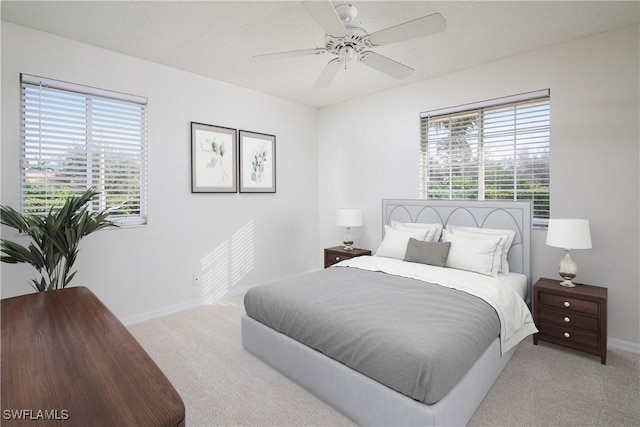 bedroom with a ceiling fan, baseboards, and carpet floors