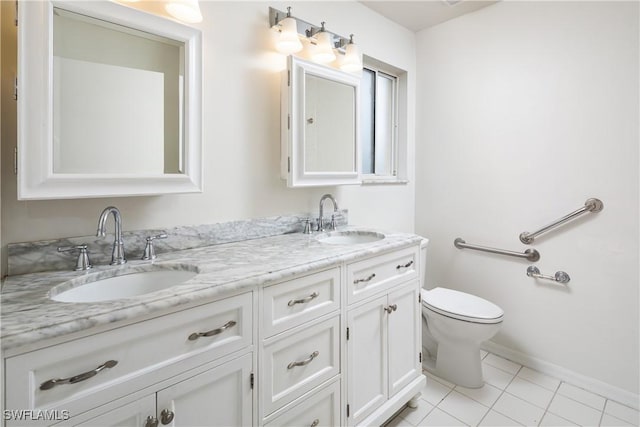 bathroom featuring a sink, toilet, double vanity, and tile patterned flooring