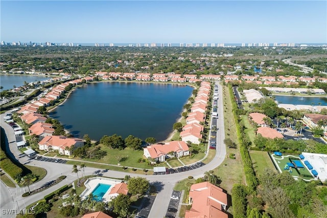 drone / aerial view featuring a view of city and a water view