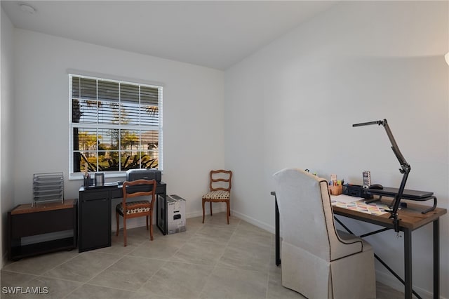 office area with light tile patterned floors and baseboards