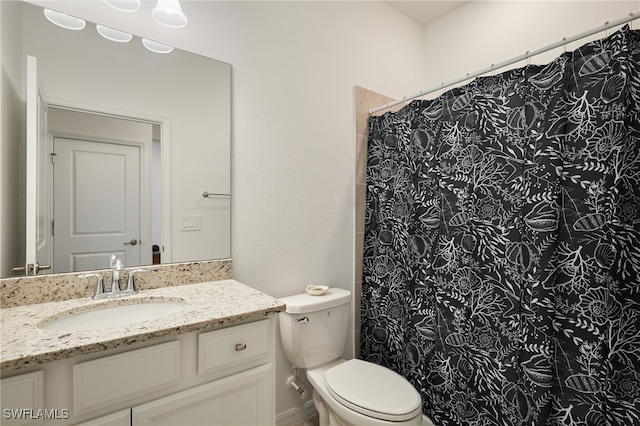 full bathroom with vanity, curtained shower, and toilet