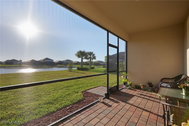 sunroom / solarium with a water view