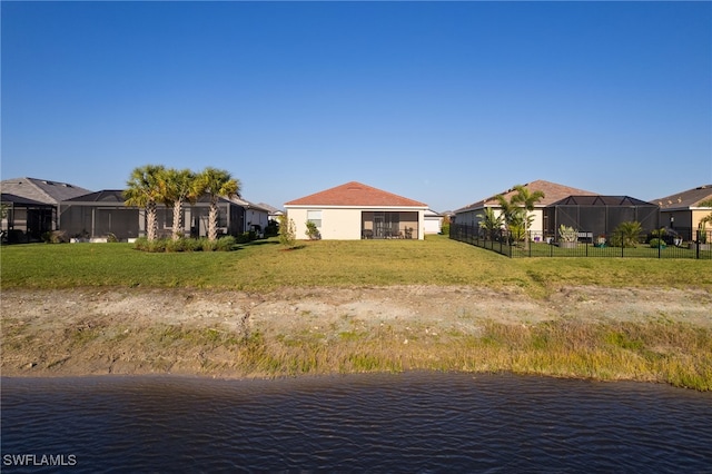 exterior space featuring a residential view, a water view, and fence