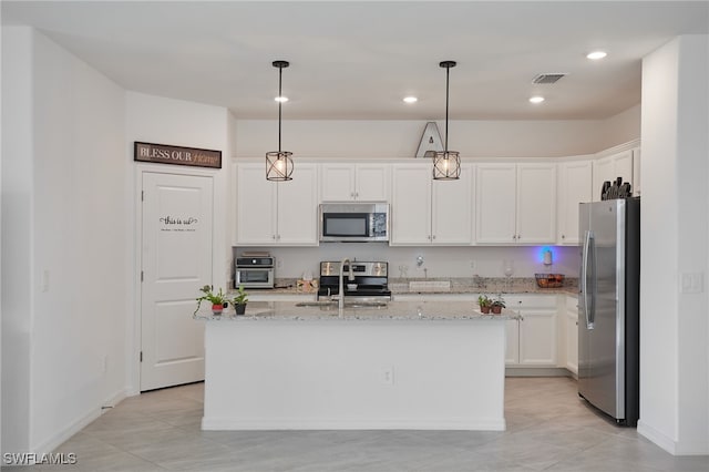 kitchen featuring visible vents, light stone countertops, appliances with stainless steel finishes, white cabinets, and a sink