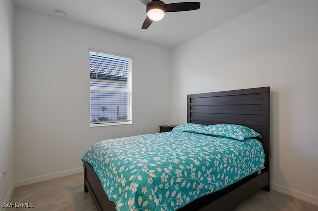 bedroom with light tile patterned floors, ceiling fan, and baseboards