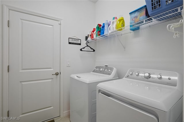 clothes washing area with washer and dryer and laundry area