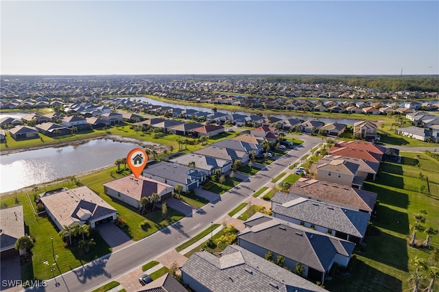 drone / aerial view featuring a residential view and a water view