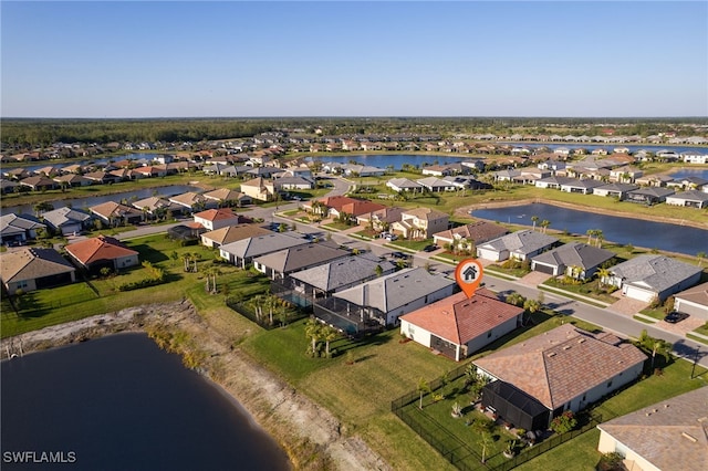 bird's eye view featuring a residential view and a water view