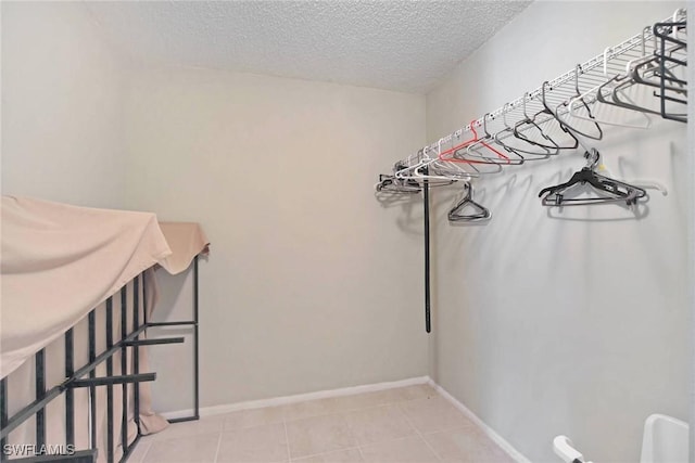 spacious closet featuring light tile patterned flooring