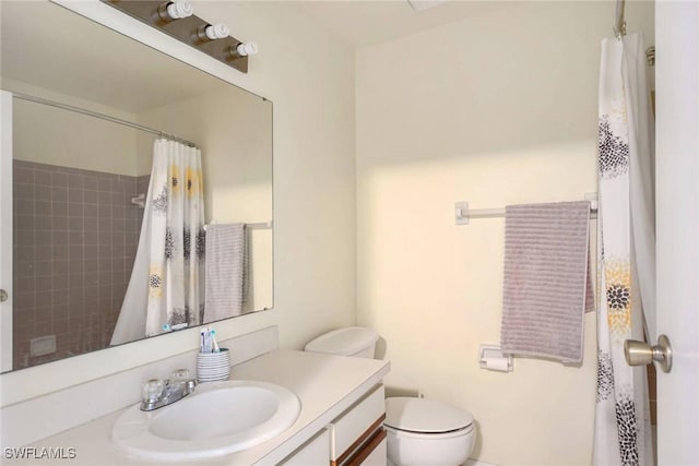 bathroom featuring vanity, a shower with shower curtain, and toilet