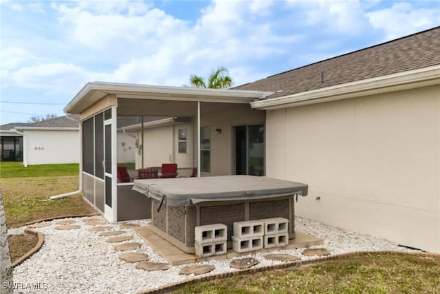 view of patio featuring a sunroom and a hot tub