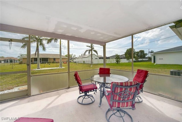 sunroom / solarium with a residential view and a wealth of natural light