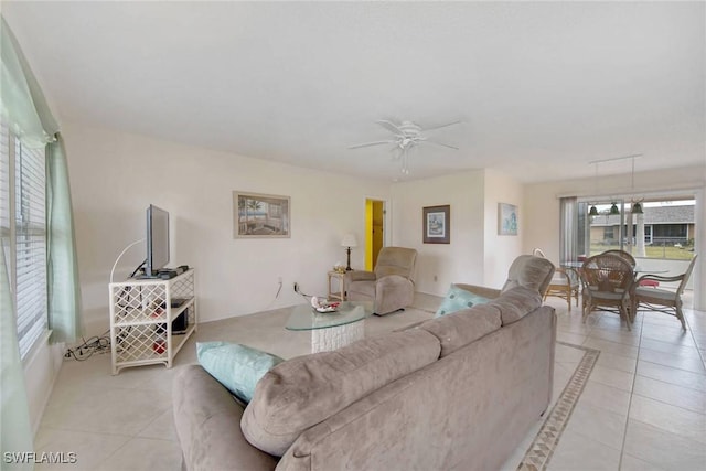 living room with light tile patterned floors and a ceiling fan