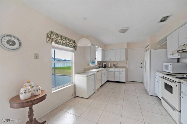 kitchen featuring white appliances, light tile patterned floors, visible vents, hanging light fixtures, and light countertops