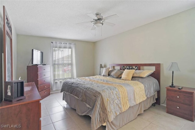 bedroom featuring a textured ceiling, ceiling fan, and tile patterned flooring