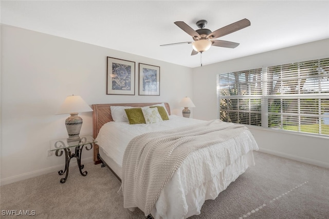 carpeted bedroom featuring baseboards and ceiling fan