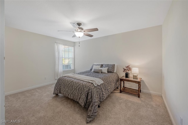 bedroom with light colored carpet, a ceiling fan, and baseboards