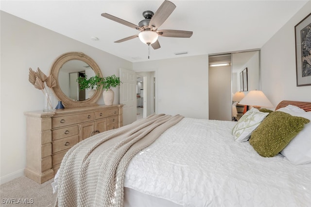 carpeted bedroom with visible vents, ceiling fan, and baseboards
