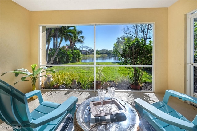 sunroom / solarium featuring a water view