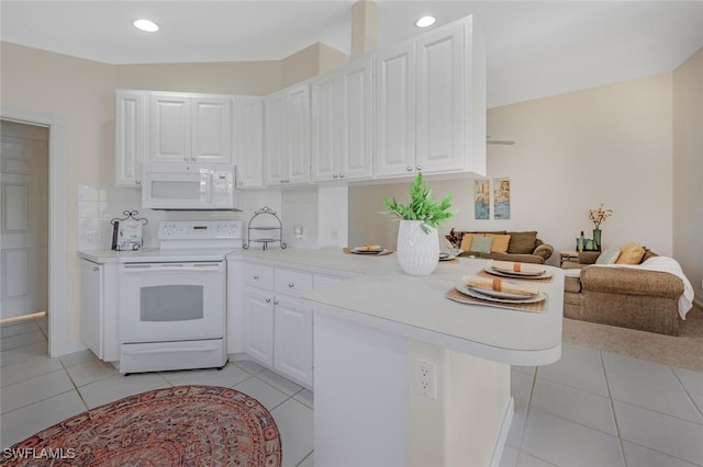 kitchen featuring white appliances, light countertops, white cabinets, a peninsula, and light tile patterned flooring