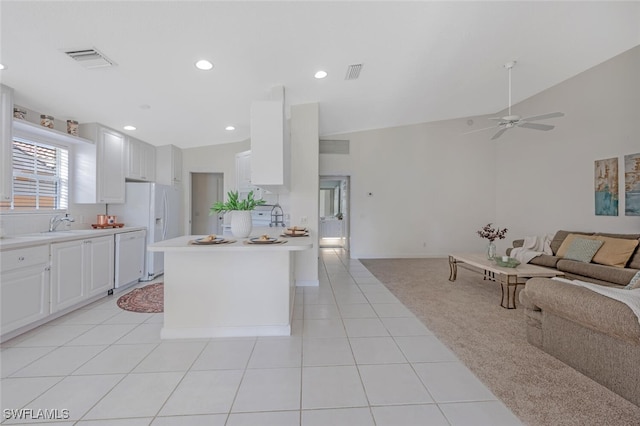 kitchen with white appliances, a ceiling fan, visible vents, light countertops, and open floor plan