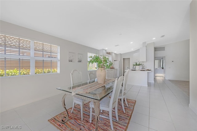 dining space with light tile patterned flooring, visible vents, and baseboards