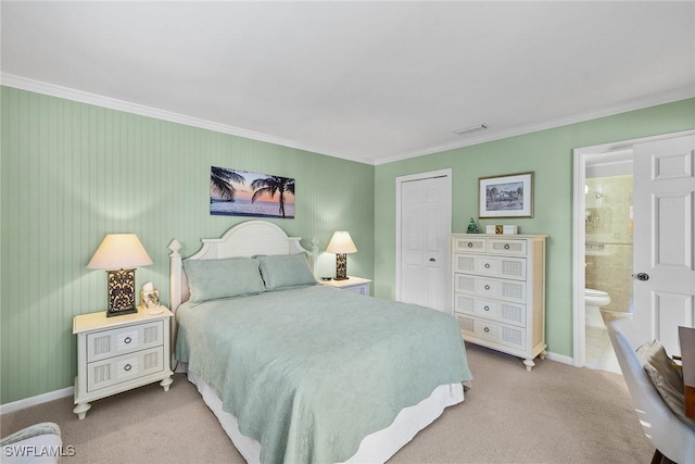 carpeted bedroom with visible vents, connected bathroom, crown molding, and baseboards