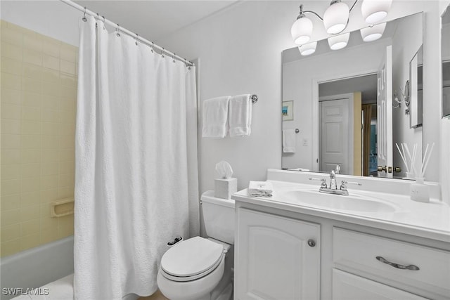 bathroom featuring vanity, shower / tub combo, and toilet