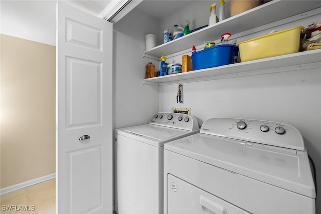 clothes washing area featuring laundry area, light tile patterned floors, baseboards, and independent washer and dryer