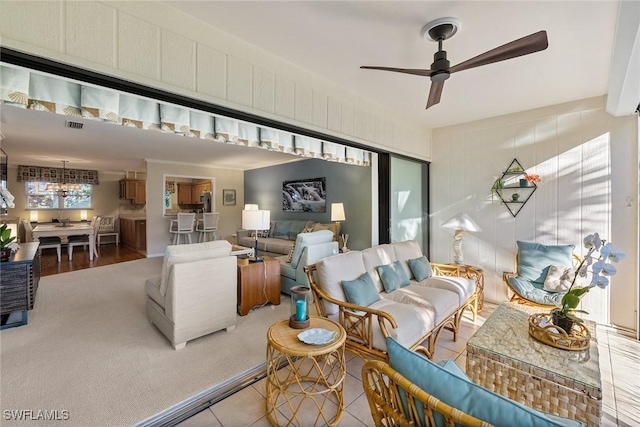 living area featuring visible vents and ceiling fan