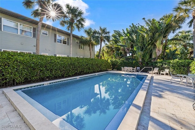 community pool with a patio area