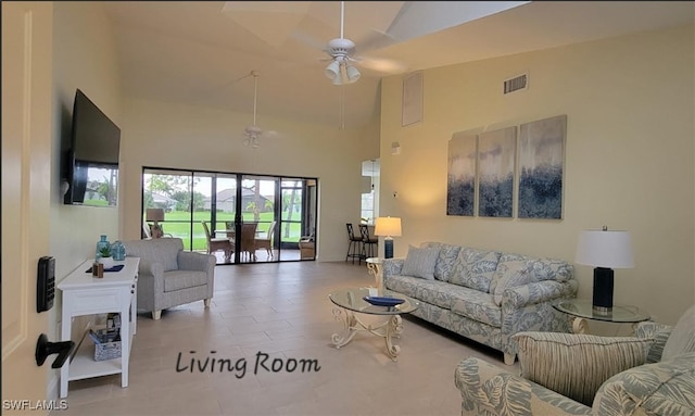 living area featuring a ceiling fan, visible vents, and high vaulted ceiling