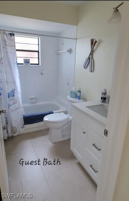 bathroom featuring tile patterned floors, shower / bath combination with curtain, toilet, and vanity