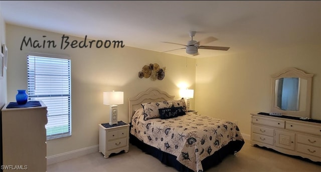 bedroom featuring a ceiling fan, baseboards, and light carpet