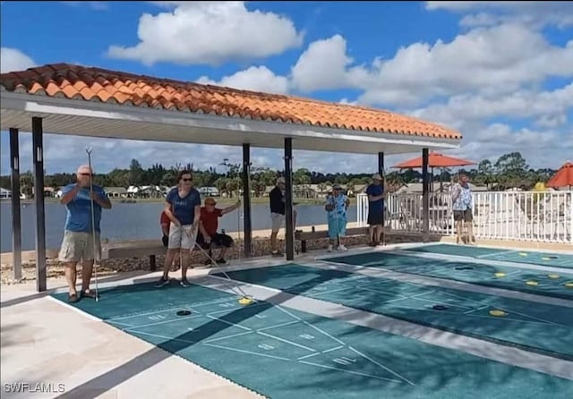 surrounding community featuring shuffleboard and fence