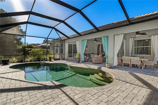 outdoor pool featuring glass enclosure, a patio, outdoor dining space, and a ceiling fan