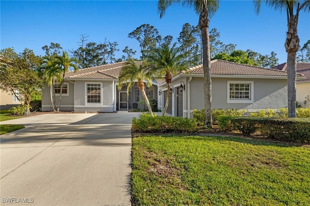 mediterranean / spanish house with stucco siding, driveway, and a tile roof