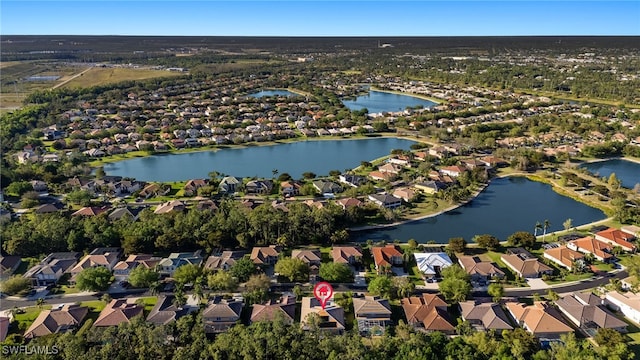 drone / aerial view with a residential view and a water view