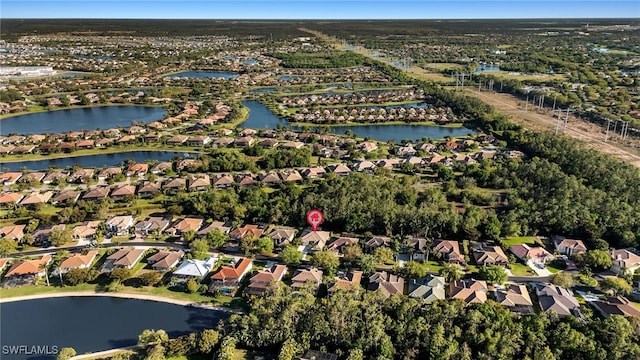 drone / aerial view with a residential view and a water view