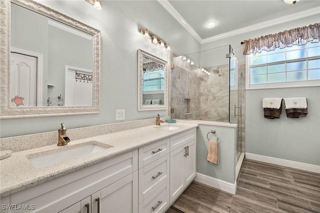 full bath featuring a sink, wood finished floors, a shower stall, and crown molding